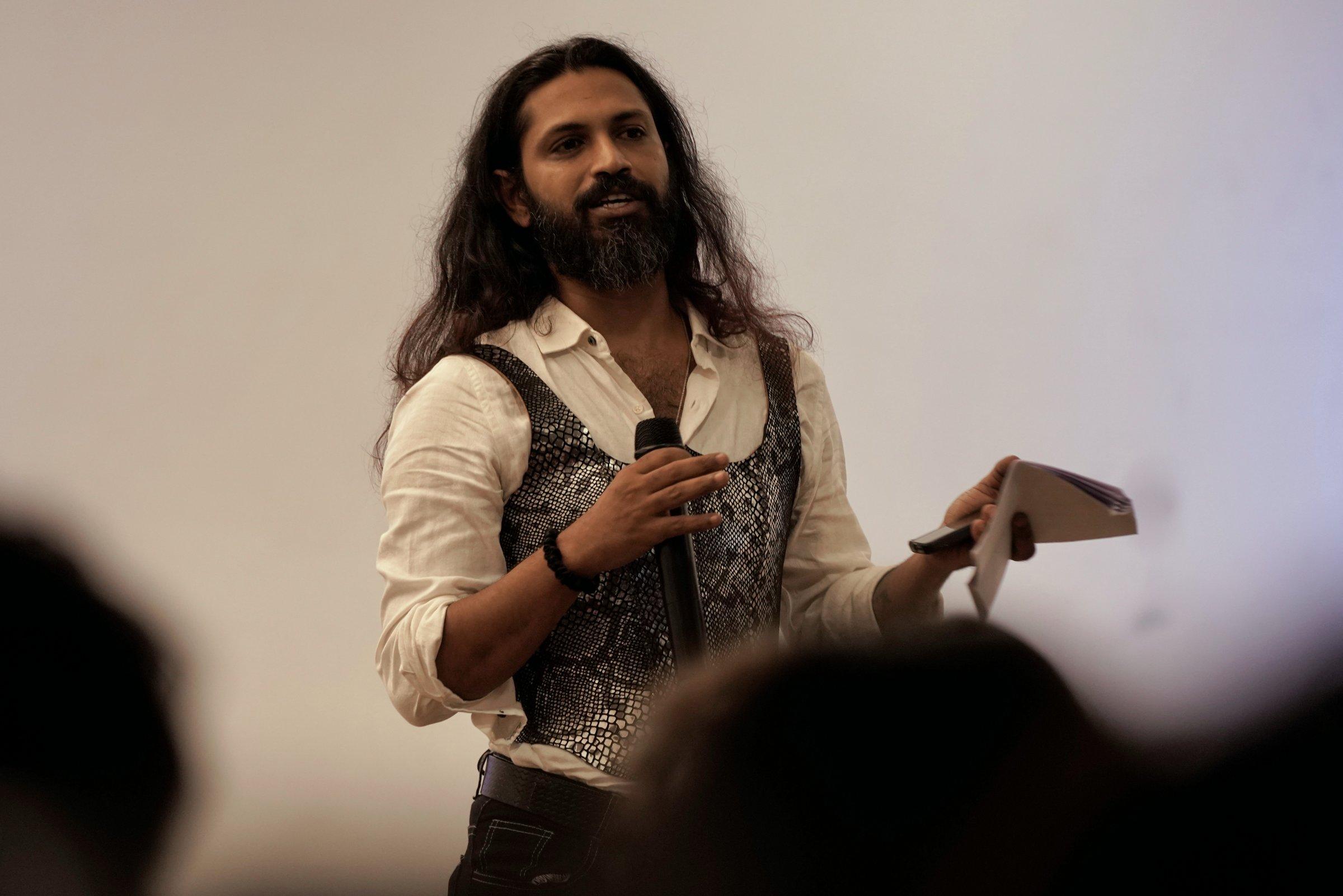 Shyam wearing Kavach on stage, the audience in the foreground