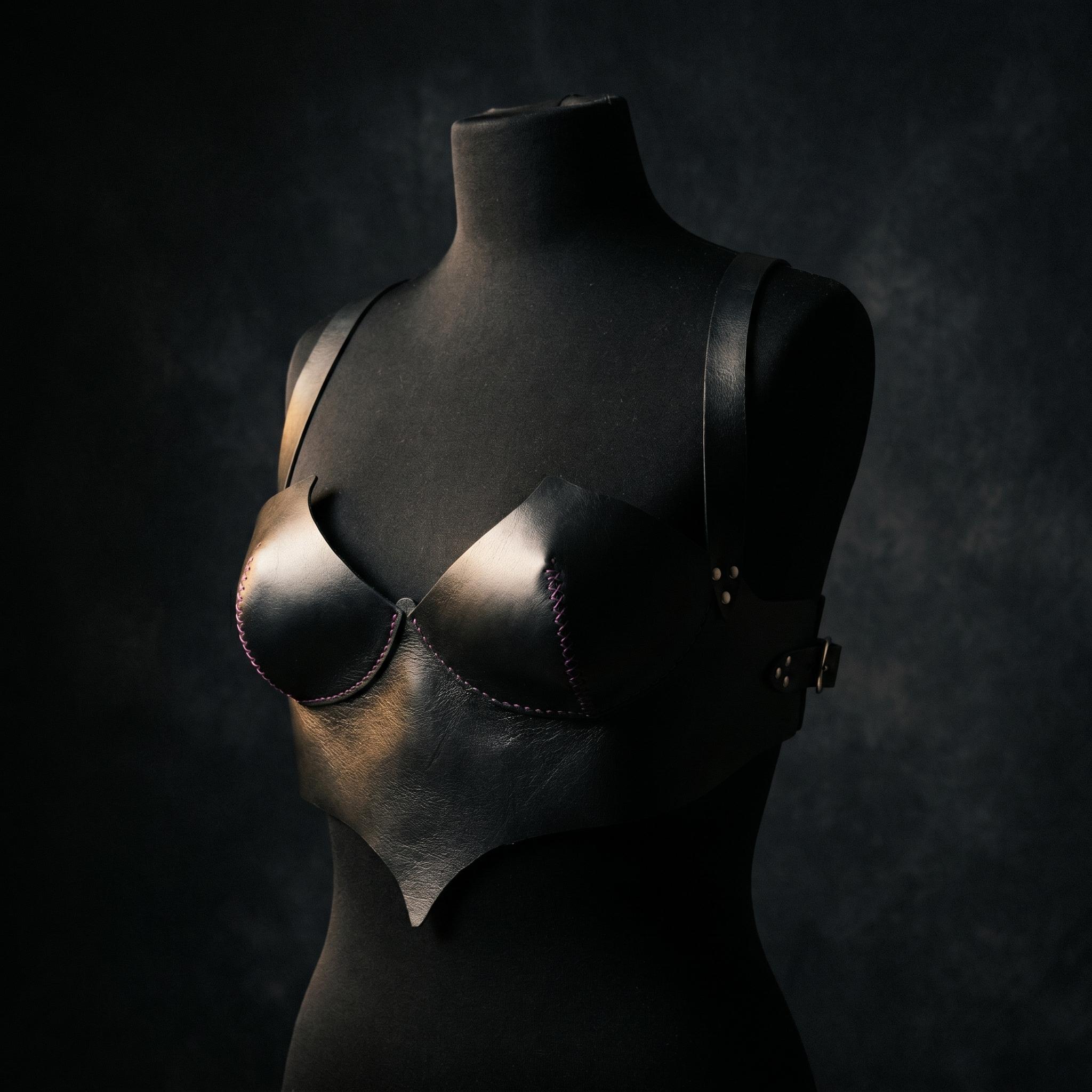 Atmospheric black-and-white editorial portrait showcasing the custom leather structure draped over a silhouette